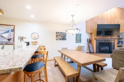 a kitchen and living room with a table and chairs at Ski Run 412 in Keystone