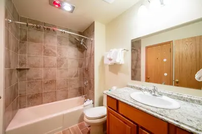 a bathroom with a sink and a tub and a toilet at Ski Run 412 in Keystone