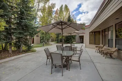 a table and chairs with an umbrella on a patio at Ski Run 412 in Keystone