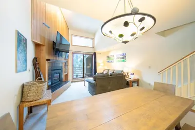 a dining room and living room with a wooden table at Ski Run 412 in Keystone