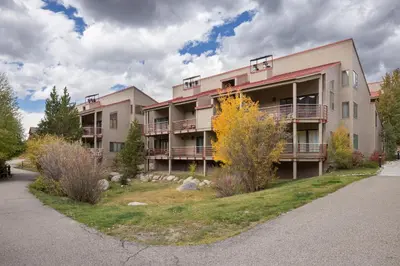 a large apartment building with a yard in front of it at Ski Run 412 in Keystone