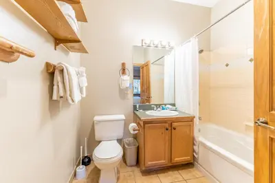 a bathroom with a toilet and a sink and a tub at Arap Ldg 8134 in Keystone
