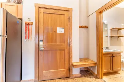 a wooden door in a kitchen next to a refrigerator at Arap Ldg 8134 in Keystone