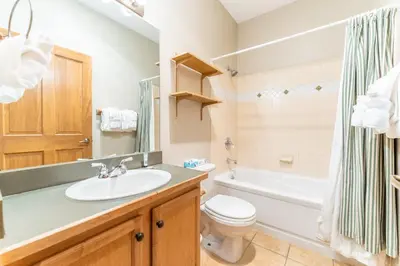a bathroom with a sink and a toilet and a tub at Arap Ldg 8134 in Keystone