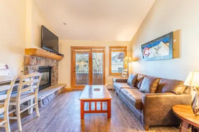 a living room with a couch and a fireplace at Arap Ldg 8134 in Keystone