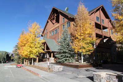 a large wooden building with trees in front of it at Arap Ldg 8134 in Keystone