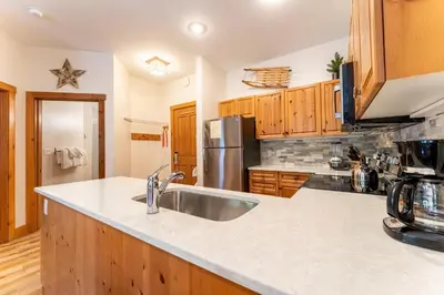 a kitchen with a sink and a refrigerator at Expedition Station 8569 in Keystone