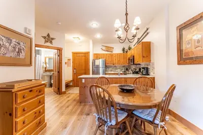 a kitchen and dining room with a wooden table and chairs at Expedition Station 8569 in Keystone