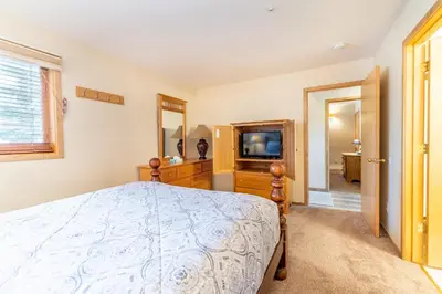 a bedroom with a bed and a television at Buffalo Ridge Village 314G in Silverthorne