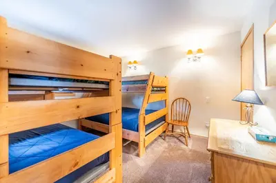 a room with two bunk beds and a desk at Buffalo Ridge Village 314G in Silverthorne