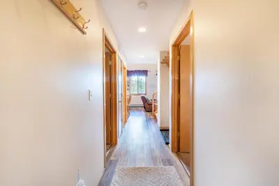 a hallway with white walls and wooden floors at Buffalo Ridge Village 314G in Silverthorne