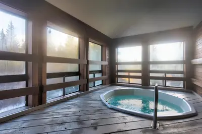 a jacuzzi tub in a room with windows at Buffalo Ridge Village 314G in Silverthorne