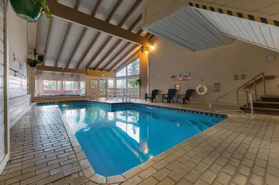 a swimming pool in a building with a large ceiling at Buffalo Ridge Village 314G in Silverthorne