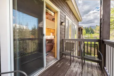 a screened in porch with two chairs and a couch at Buffalo Ridge Village 314G in Silverthorne