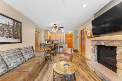 a living room with a couch and a fireplace at Expedition Station 8571 in Keystone
