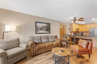 a living room with couches and a kitchen at Expedition Station 8571 in Keystone