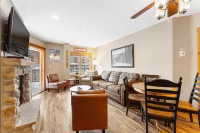 a living room with a couch and a fireplace at Expedition Station 8571 in Keystone