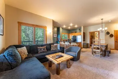 a living room with a couch and a table at Expedition Station 8568 in Keystone