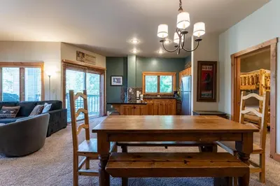a living room with a wooden table and a couch at Expedition Station 8568 in Keystone