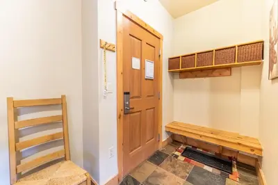 a hallway with a wooden door and a shelf at Expedition Station 8568 in Keystone