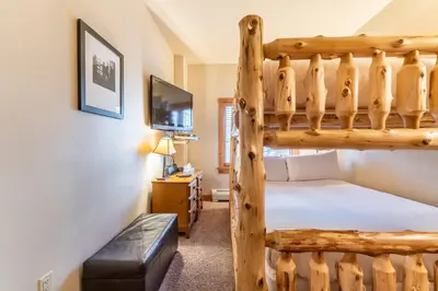 a bedroom with a bunk bed and a tv at Expedition Station 8568 in Keystone