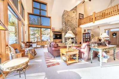 a living room with furniture and a stone wall at 94 Ryan Gulch Road in Silverthorne