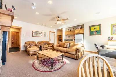 a living room with couches and a table at 94 Ryan Gulch Road in Silverthorne