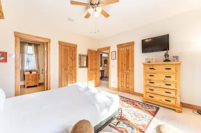 a bedroom with a bed and a flat screen tv at 94 Ryan Gulch Road in Silverthorne