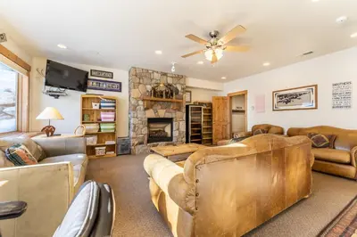 a living room with leather furniture and a fireplace at 94 Ryan Gulch Road in Silverthorne