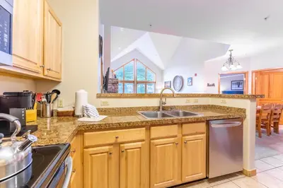 a kitchen with wooden cabinets and a sink at Gateway 5098 in Keystone