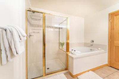 a bathroom with a shower and a tub and a sink at Gateway 5098 in Keystone