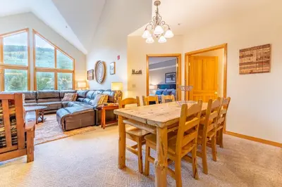 a dining room and living room with a table and chairs at Gateway 5098 in Keystone