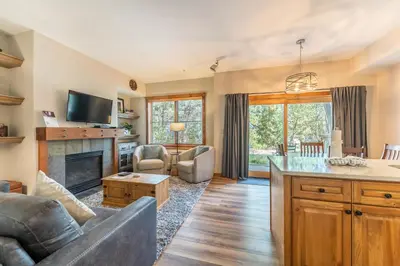 a living room with a couch and a fireplace at Seasons at Keystone 1836 in Keystone