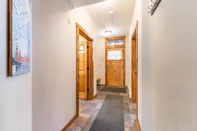 a hallway with a door and a mirror at Seasons at Keystone 1836 in Keystone