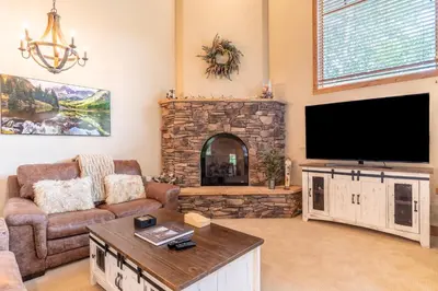 a living room with a large flat screen tv at Autumn Brook 22 in Keystone