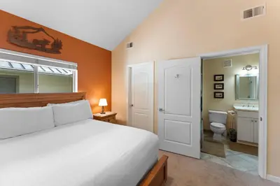 a bedroom with a bed and a bathroom with a toilet at Prospect Point Townhomes 202C in Frisco