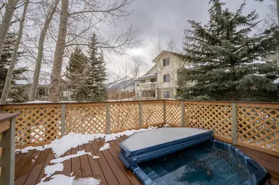 a hot tub on a wooden deck in the snow at Prospect Point Townhomes 202C in Frisco