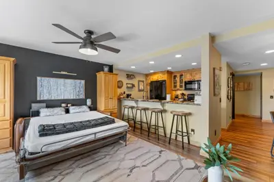 a bedroom with a large bed and a kitchen at Saints John 2539 in Keystone