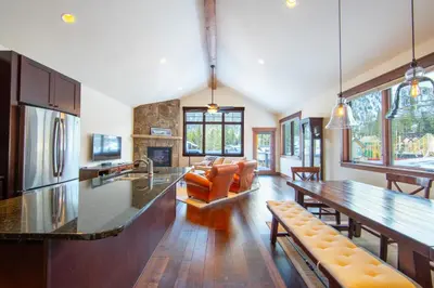 a kitchen and living room with a table and chairs at Alders 74 in Keystone