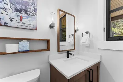 a bathroom with a sink and a mirror at Alcove 75 in Keystone