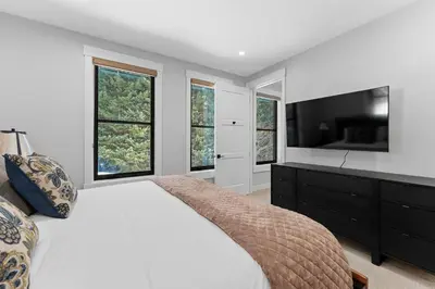 a bedroom with a large bed and windows at Alcove 75 in Keystone