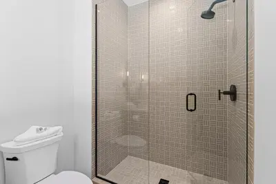 a bathroom with a glass shower with a toilet at Alcove 75 in Keystone