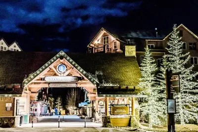 a building with a christmas tree in front of it at Alcove 75 in Keystone