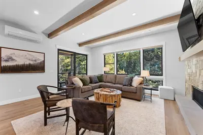 a living room with a couch and a fireplace at Alcove 75 in Keystone