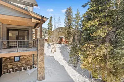 a winter view of a house with a snow covered driveway at Alcove 75 in Keystone