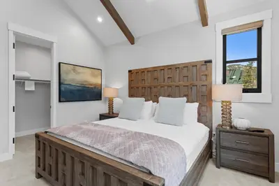 a bedroom with a large bed and a window at Alcove 75 in Keystone