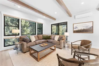 a living room with a couch and a table at Alcove 77 in Keystone