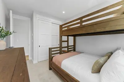 a bedroom with a wooden bunk bed and a desk at Alcove 77 in Keystone