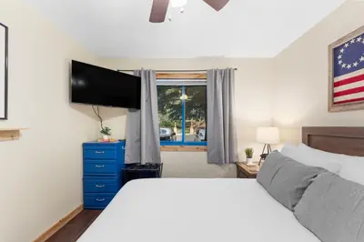 a bedroom with a bed and a flat screen tv at Snowdance 103 Building A in Keystone