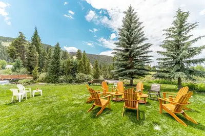 a group of chairs and tables on a lawn at Snowdance 103 Building A in Keystone